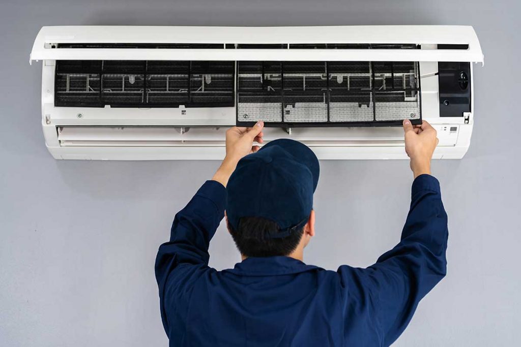 technician working on an AC unit for repair